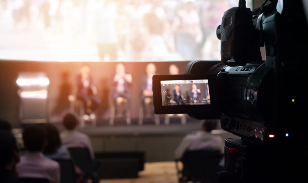 Video Presentation media and live streaming record and broadcast in real time for social network concept. VDO camera taking live video streaming at seminar technology event with flare light effect.